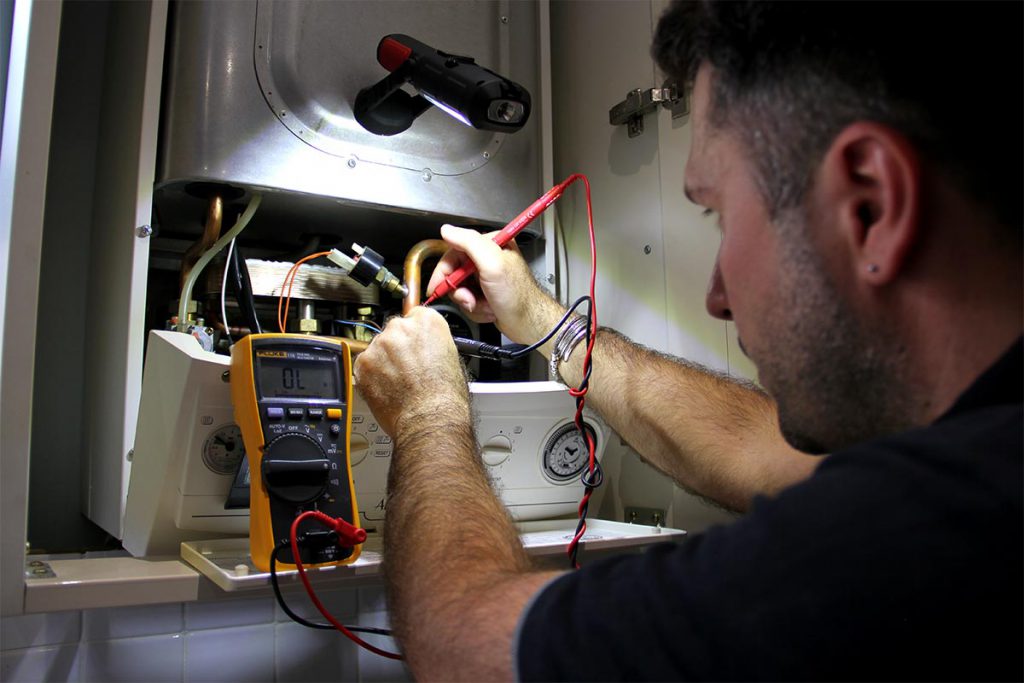 A local, technical heating engineer repairing a Vaillant Ecotec gas boiler during an emergency repair in South East London, Sydenham – SE26.