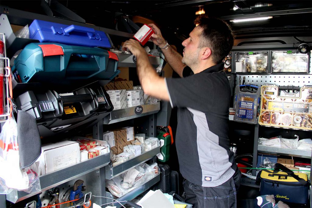 A skilled Boiler Bunny Heating engineer looking through tools in his service van to repair a Vaillant boiler in SE26, South East London.