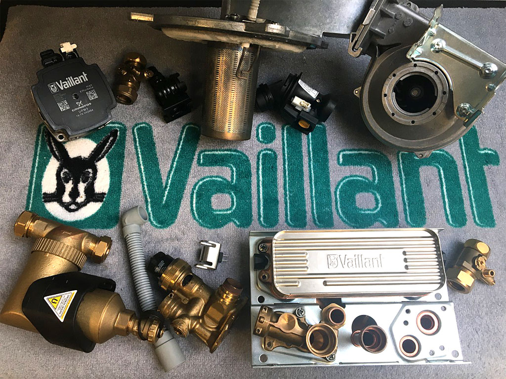 Vaillant boiler parts removed by a Vaillant Advance engineer during a Vaillant boiler service in South London - a pump, fan, heatexchanger, divertor valve and PCB.